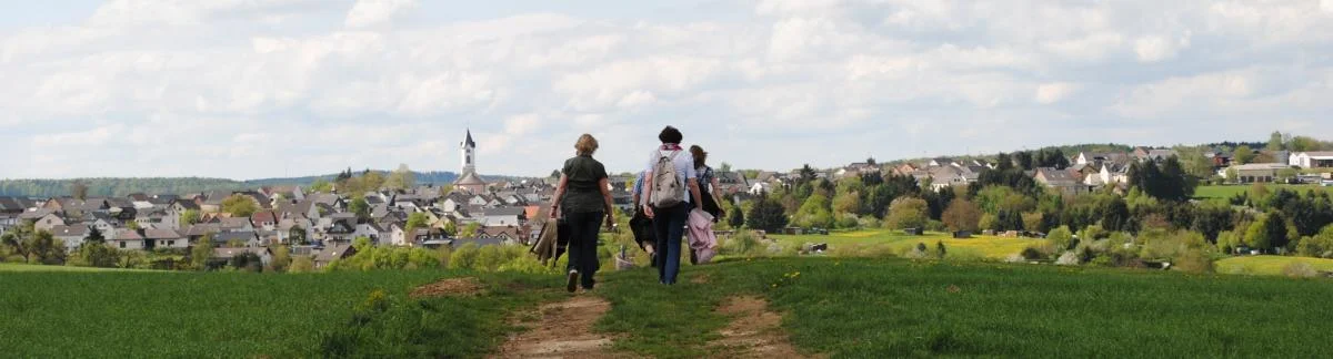 Wanderer auf Feld mit Kirche